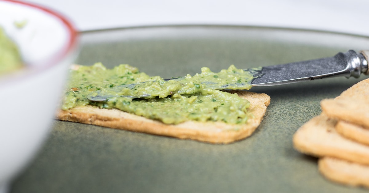 Basil pesto with avocado, garlic, olives and nutritional yeast
