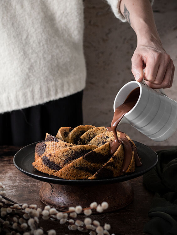 Pour dark chocolate sauce over the eggless bundt cake