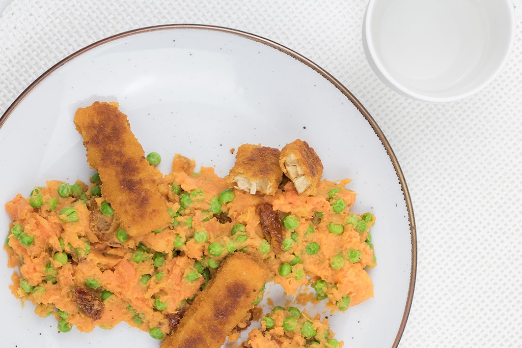 Healthy mashed sweet potatoes with vegan fish fingers photographed from above