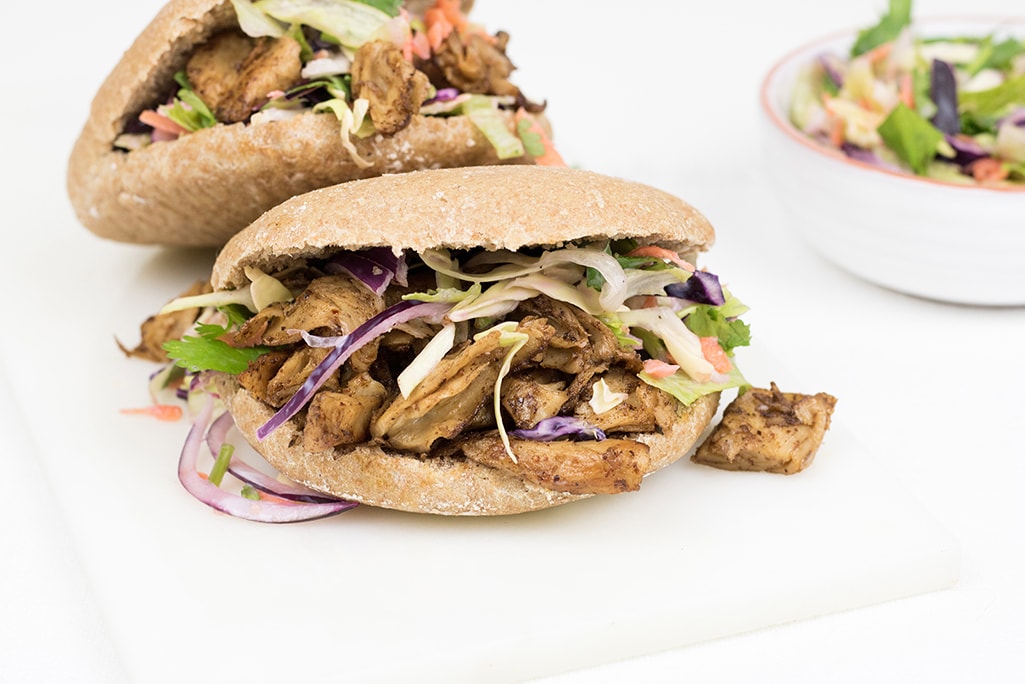 Vegan jerk chicken with pita bread and salad