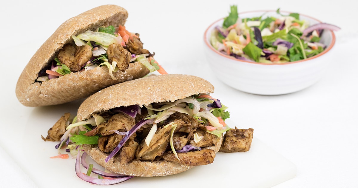 Vegan jerk chicken, stuffed whole grain pita with healthy salad