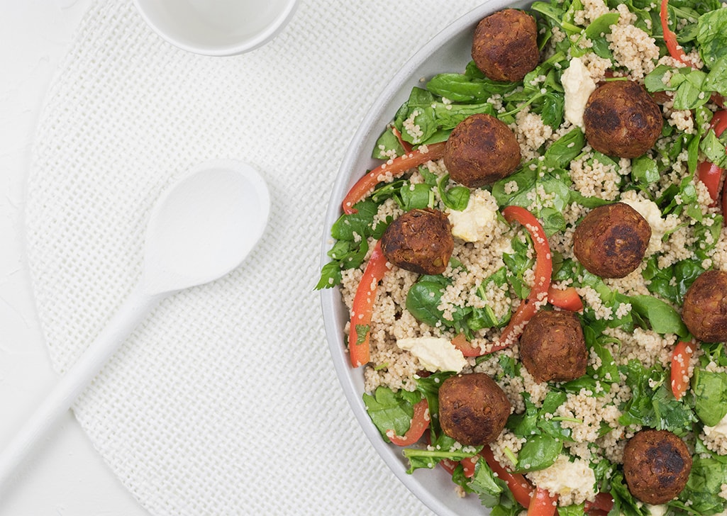 Vegan lentil meatballs with healthy couscous salad photographed from above