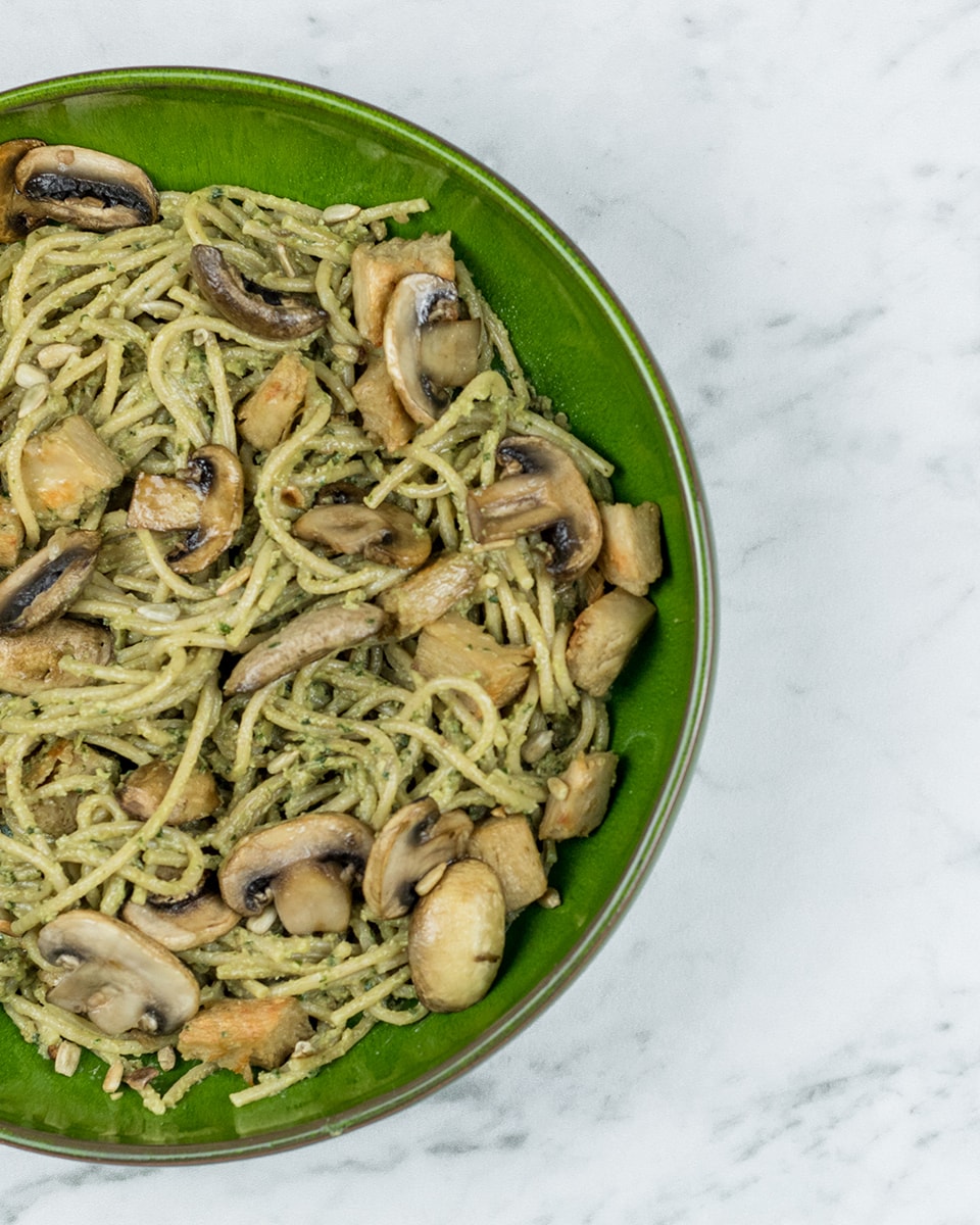 Vegetarian pesto pasta with mushrooms and plant-based chicken
