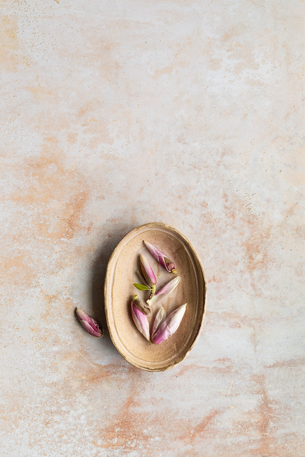 White stone backdrop with peach details ideal for photography