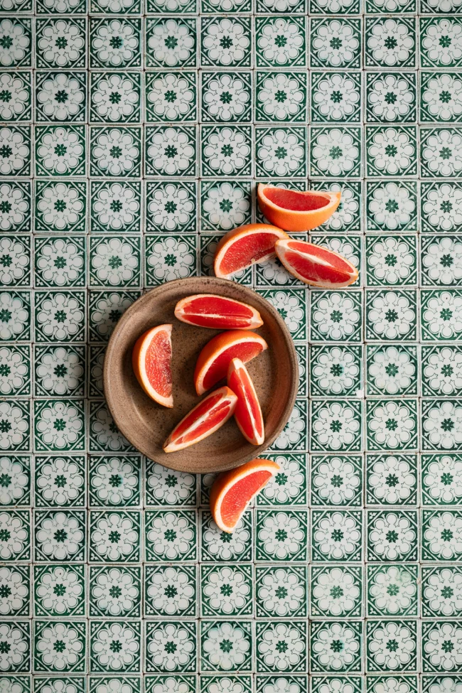 Green tiles flatlay surface with flower pattern for photo and video